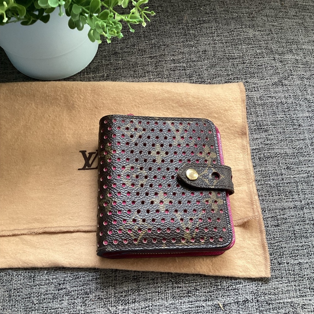 LOUIS VUITTON
Limited Edition Fuchsia Monogram Perforated Compact Zip Wallet